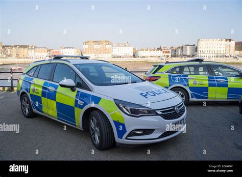 Marked Kent Police cars attended an incident at Margate Pier sea front, Kent, England Stock ...