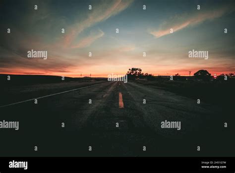 Beautiful view of an empty road under the sunset sky Stock Photo - Alamy