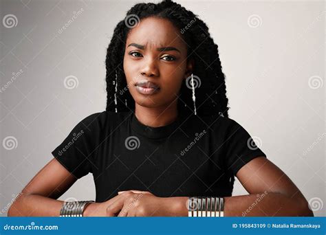 Serious Young Black Woman Wearing Black T-shirt. Isolated Over White ...