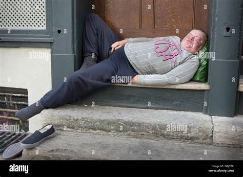 drunk man sleeping in doorway Stock Photo - Alamy