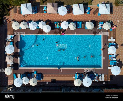 Aerial view on people in swimming pool. Top view of people sunbathing ...