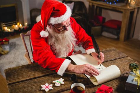 Santa Claus Writing on Scroll in Living Room Stock Photo - Image of ...