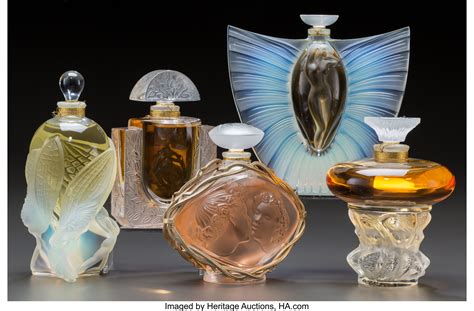 Five Lalique Glass Factice Perfume Bottles. Le Baiser, Sylphide, | Lot #79397 | Heritage Auctions