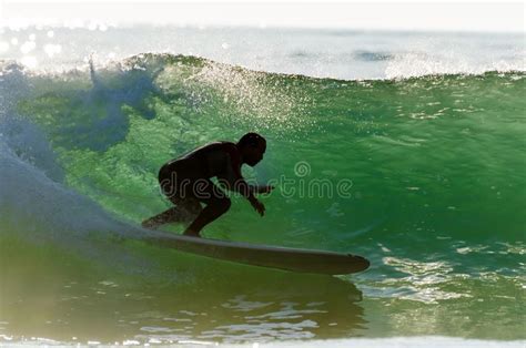 Long Boarder Surfing the Waves at Sunset Stock Photo - Image of portugal, orange: 128081402