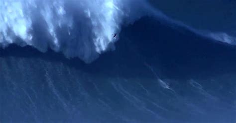 Surfer breaks world record by riding 80-foot wave - CBS News