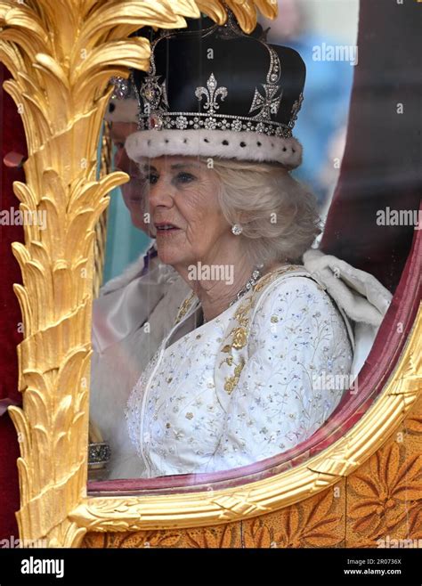 King Charles III and Queen Camilla make their way along The Mall, London, during the Coronation ...