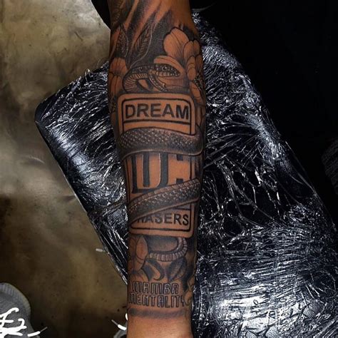 Dream Chasers Logo with Snake Forearm Tattoo