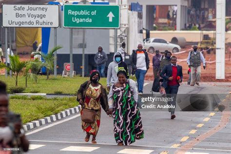 People wait cross the Katuna border crossing between Uganda and... News Photo - Getty Images