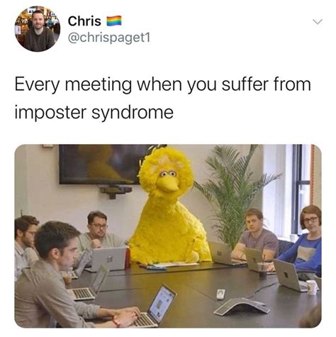 people sitting around a table with laptops and a large stuffed animal in the middle