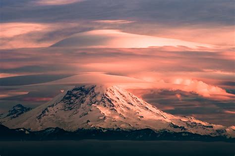 A stunning double lenticular cloud atop Mt. Rainier, taken yesterday at sunset : r/Seattle