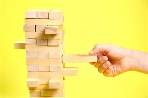 Premium Photo | Game of wooden blocks on a yellow background