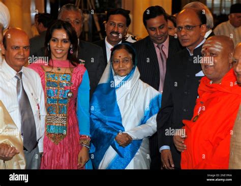 Indian President Pratibha Patil, center, poses for photographs with some of the receipients of ...