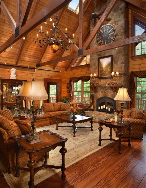 A massive stone fireplace anchors this custom log home. The timber frame trusses and metal ...