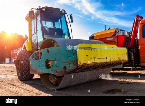 The asphalt roller is parked with other construction equipment Stock ...