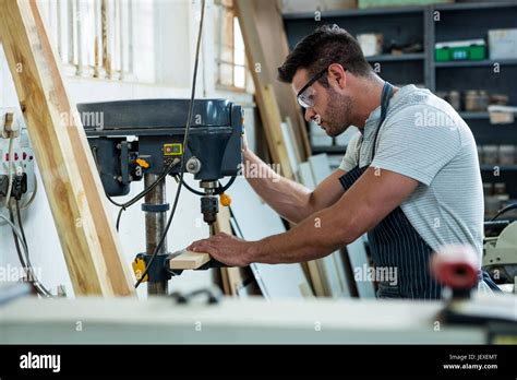 Carpenter using a drill Stock Photo - Alamy