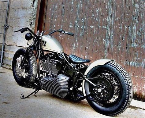 Classic Bobber Motorcycle Parked in Front of a Wooden Door