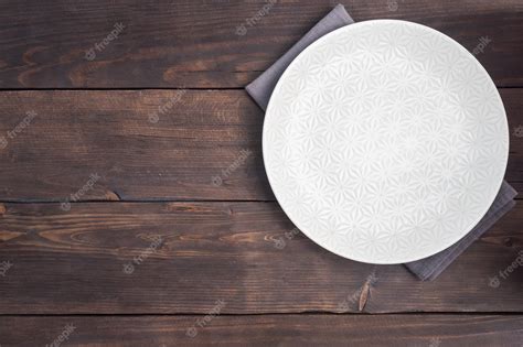 Premium Photo | Empty white plate on wooden rustic background. top view ...