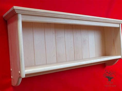 a wooden shelf on a red wall
