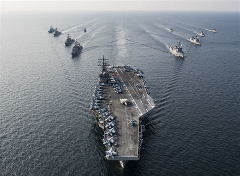 The aircraft carrier USS Ronald Reagan and its accompany strike group ...