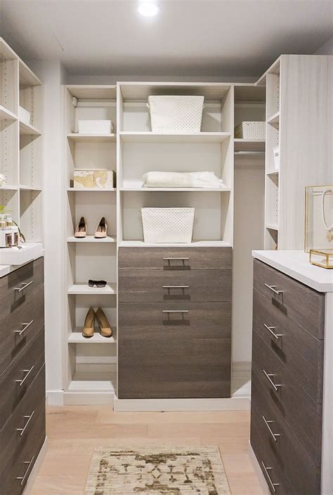 This walk-in closet was designed by Debra Russo, a designer at California Closets. This clean ...