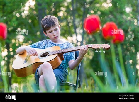 Boy playing guitar Stock Photo - Alamy