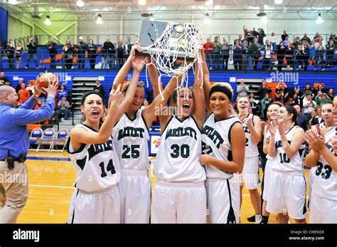 High school basketball team players celebrate an overtime sectional ...