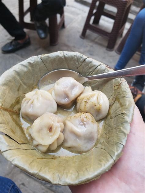 Buffalo Momo. Street food in Kathmandu, Nepal. Note the dried leaf bowl ...