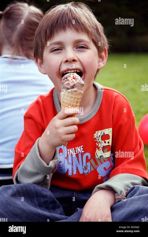 Young boy eating ice cream Stock Photo - Alamy