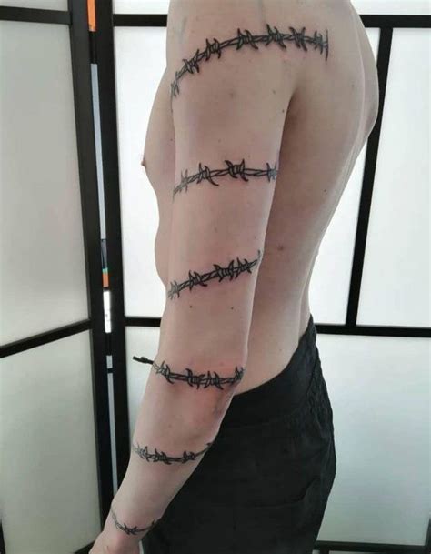 a man with barbed wire on his arm