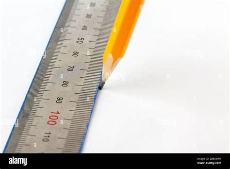 Pencil draw a straight line with the help of a ruler Stock Photo - Alamy