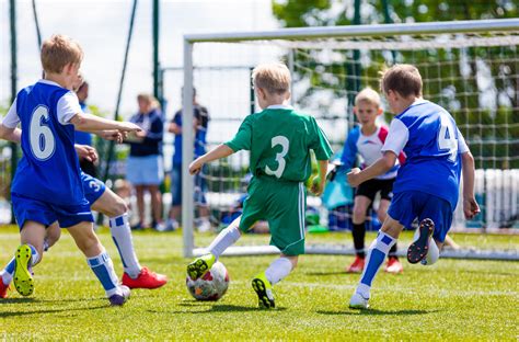 Football soccer match for children. Boys playing football game on a ...