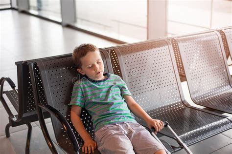 Tired Child Sleeping in Waiting Room for Passengers. Stock Photo ...