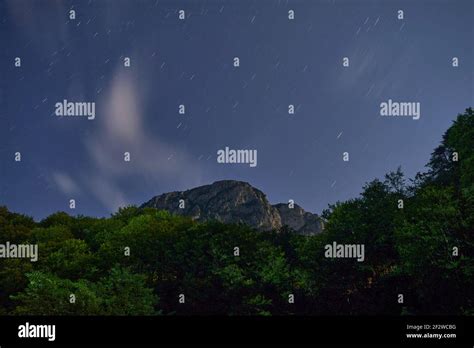 night photography of sky mountain and forest Stock Photo - Alamy