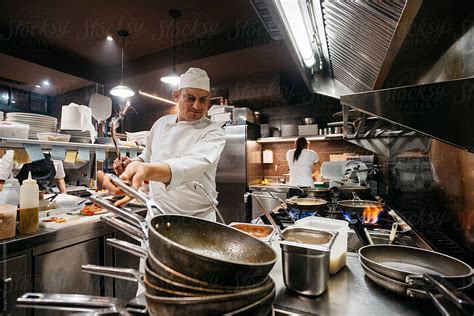 «Professional Chef Cooking In Restaurant Kitchen» del colaborador de Stocksy «Sergio Marcos ...