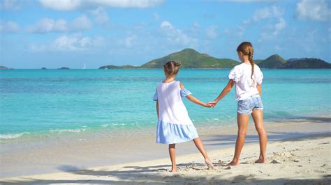 Two kids on the beach on caribbean island 20054775 Stock Video at Vecteezy