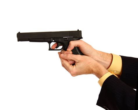 Pistol | Free Stock Photo | A hand in a business suit holding a pistol | # 13267