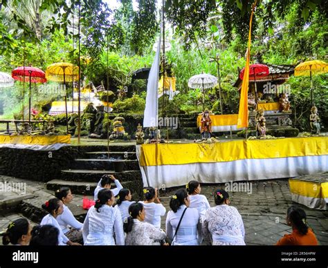 Bali Hinduism, devout people praying in front of shrine in Taman Beji Griya Waterfall, Kabupaten ...