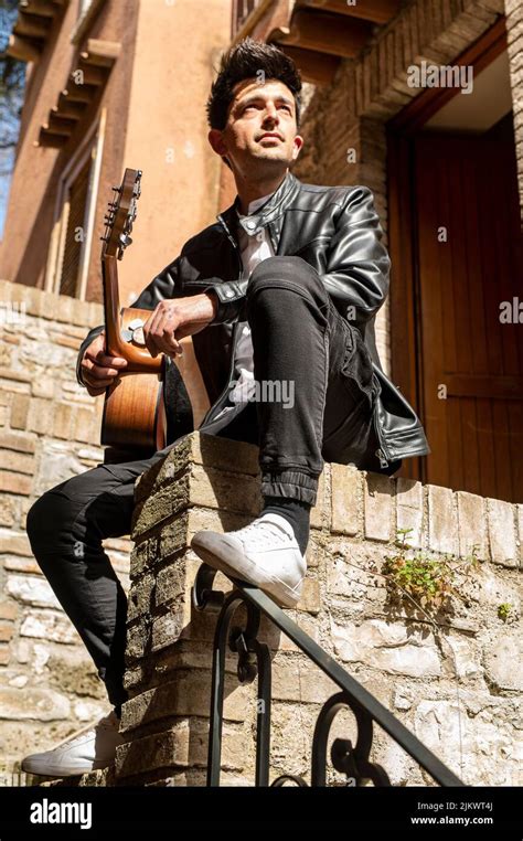 boy holding guitar outdoors posing during daytime Stock Photo - Alamy