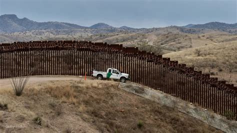 Smugglers help migrants scale border wall ‘using $5 ladders’