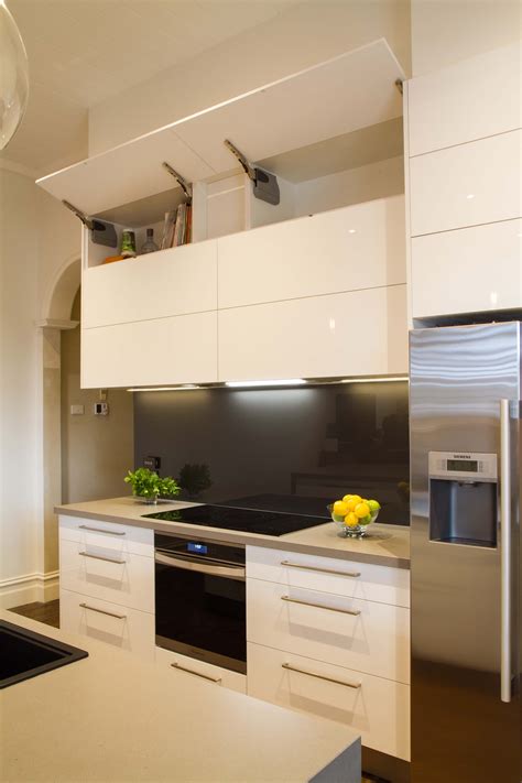 Modern galley style kitchen. Lift up overhead cupboards by Blum. www ...