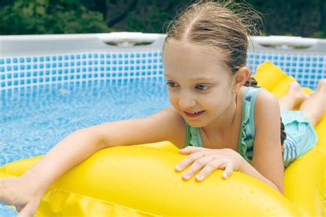 Premium Photo | Little girl lying on pool float