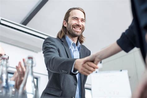 Premium Photo | Businessman and businesswoman shaking hands in office