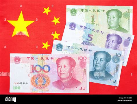 Chinese currency Yuan notes on the chinese flag Stock Photo - Alamy