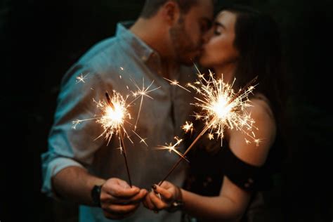 A couple posing while holding sparkles | Twin flame relationship, Twin ...