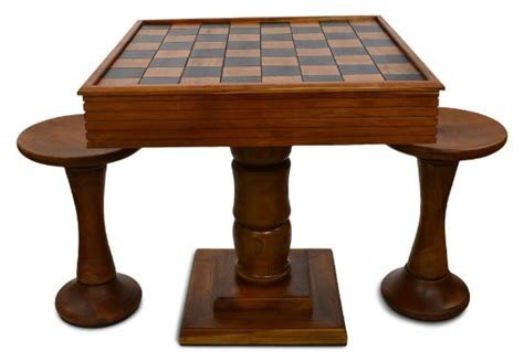 a wooden table with two stools and a chess board on top
