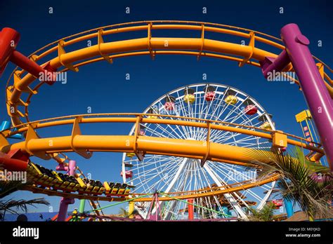 Roller coaster and ferris wheel at Santa Monica Pier, California Stock Photo - Alamy