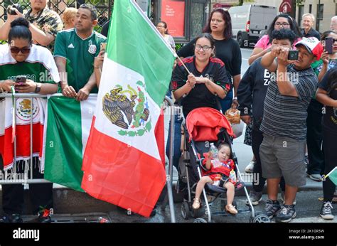 Spectator is seen holding a Mexican flag during the annual Mexican Day ...