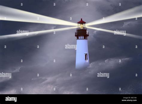 Lighthouse in storm with beams Stock Photo - Alamy