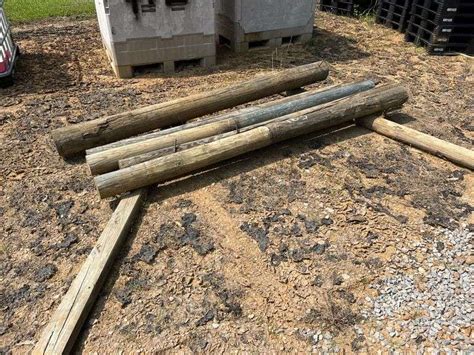 (7) Round Fence Posts, Treated - Taylor Auction & Realty, Inc.