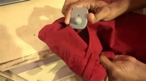 Simple way of removing security tag from clothing - YouTube